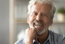 An elderly man enjoying his dentures