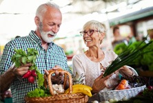 : An older couple buying healthy foods