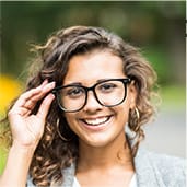 girl with glasses on smiling