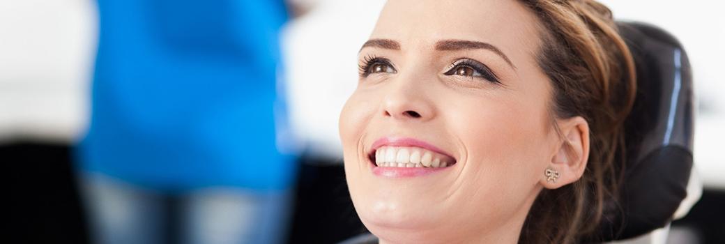 Smiling woman visiting her Greensboro cosmetic dentist