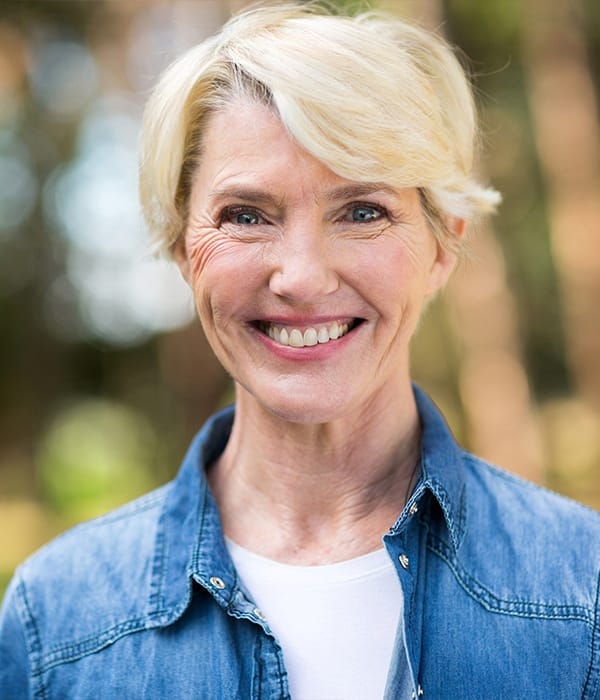 woman in jean jacket smiling