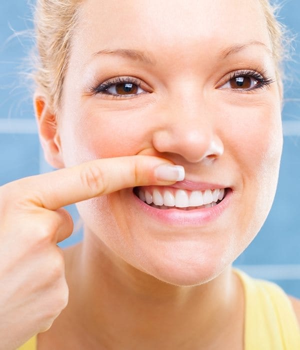 woman pointing to gums