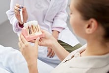 Greensboro implant dentist explaining how dental implants work