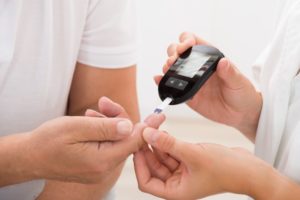 diabetes patient getting finger pricked