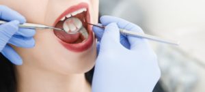 a woman getting her teeth cleaned