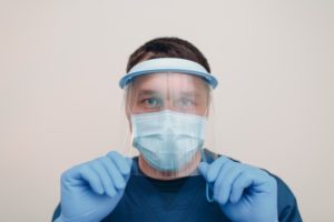 Dentist in Greensboro wearing face shield