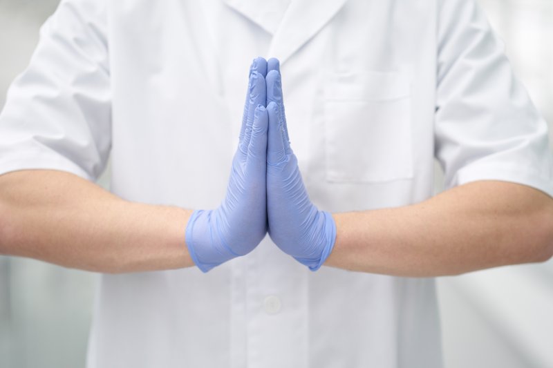 Dentist in Greensboro doing namaste greeting