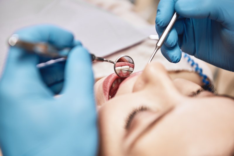 Dentist conducting a dental exam on patient