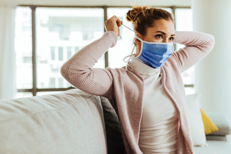 Woman putting on a face mask