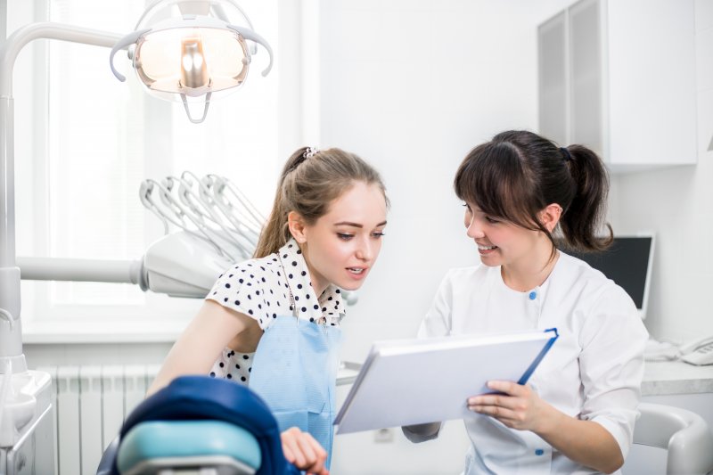 woman speaking with her cosmetic dentist in Greensboro