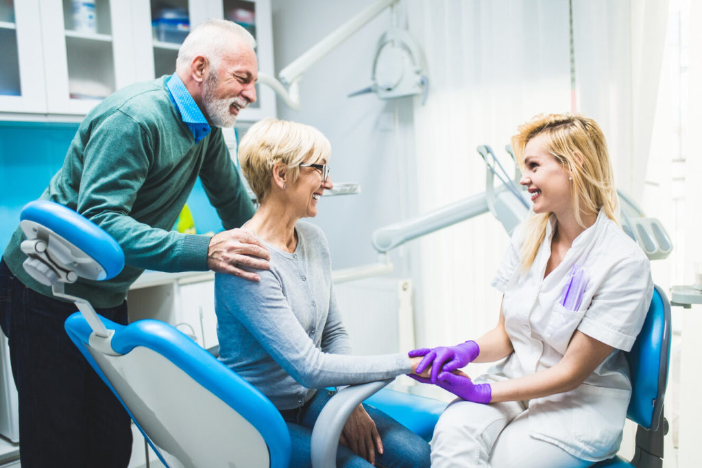 couple learning about dental financing at dental office 