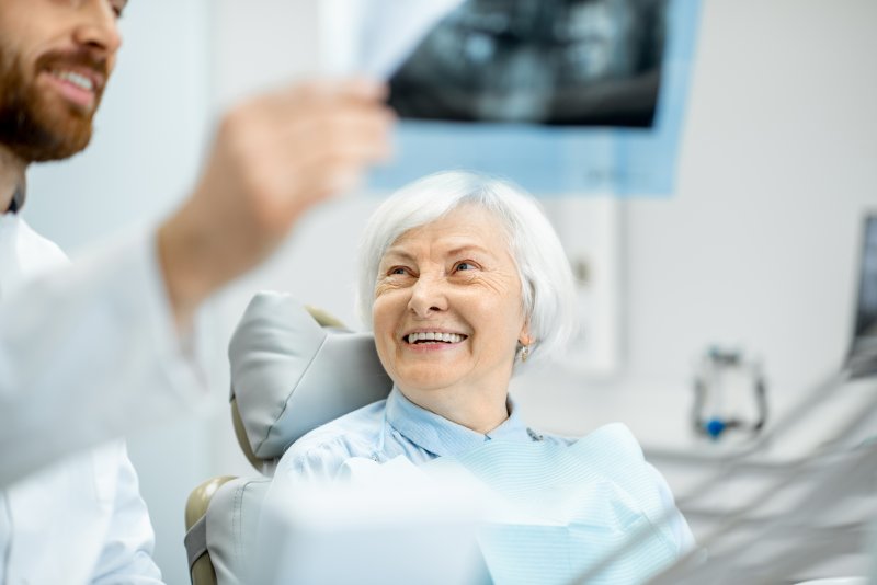 Happy senior woman at dentist.