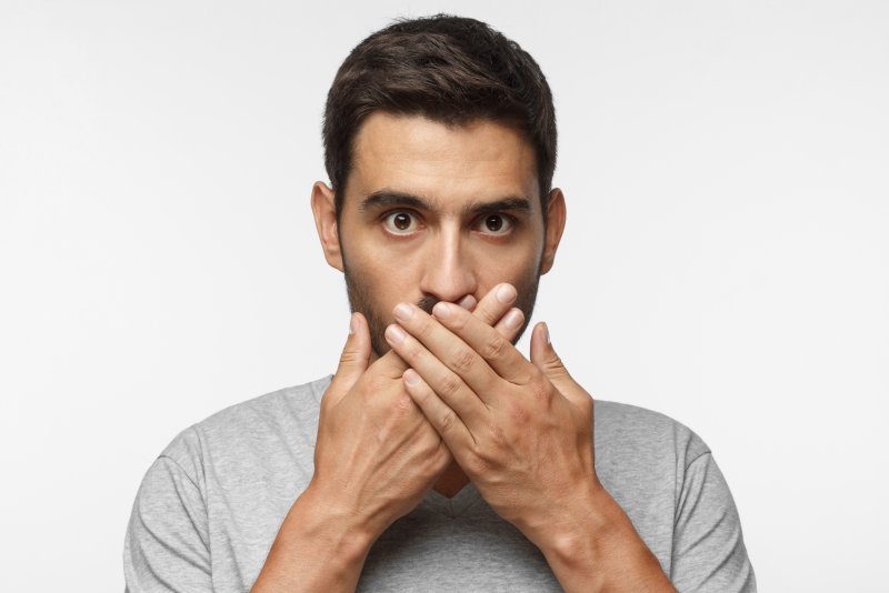 Man covering his mouth