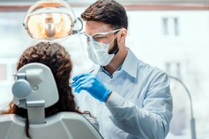 Dentist performing a tooth extraction on a patient.