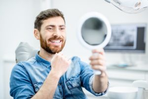 man seeing his smile after replacing his metal fillings 