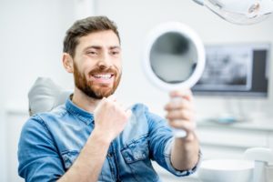 man seeing his smile after replacing his metal fillings