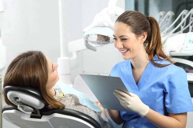 dentist explaining dental implant surgery to patient