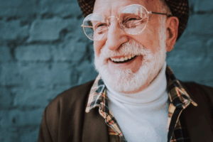 Fashionable man smiling on blue background