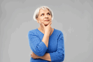 Woman rubbing her chin in a questioning pose