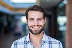 Man smiling after getting his permanent veneers