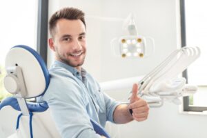 Man smiling after getting his fallen veneer reattached