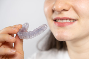 Close-up of woman holding an occlusal splint