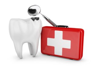 Dental emergency kit sitting next to tooth and dental tool.